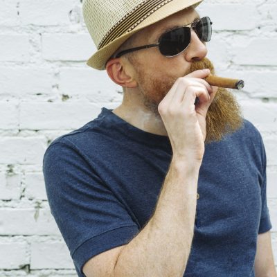 Bearded man smoking a cigar