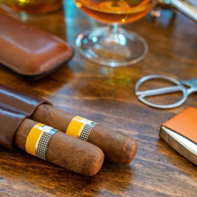 Cuban cigars and smoking accessories on wooden desk